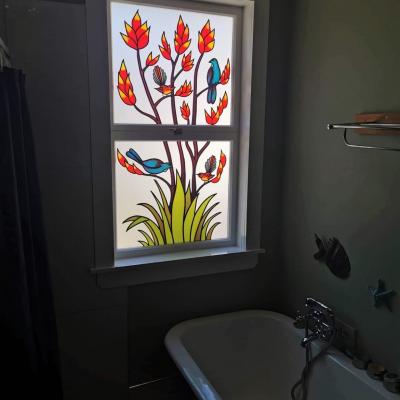 installed tui and fantail with flax - custom leadlight llw - angled view